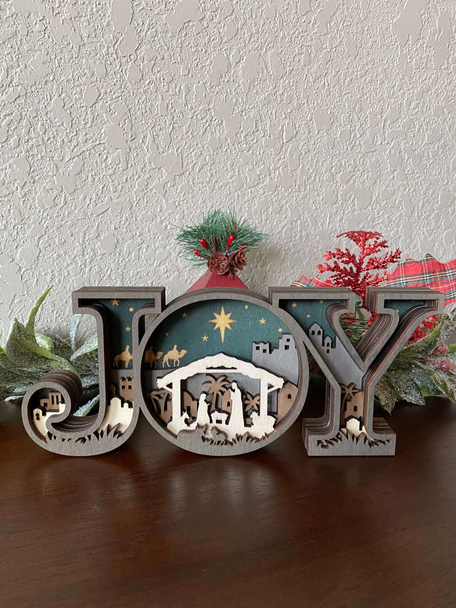 Layered wooden JOY Nativity Scene sign featuring the manger and Star of Bethlehem, handmade Christmas decoration by Yellow Rose TX Crafts.