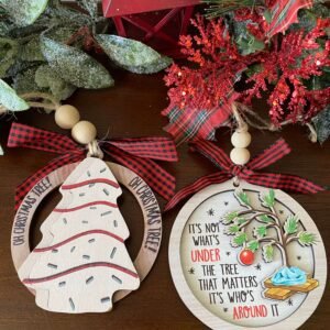 Set of two layered wooden Christmas ornaments — ‘Oh Christmas Tree’ and ‘It’s Not What’s Under the Tree’ designs, handmade by Yellow Rose TX Crafts.